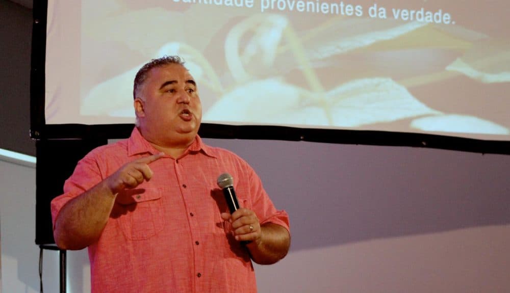 Pastor Joe Souza gives a bilingual sermon at Celebration Church's Charlestown service. (Paris Alston/WBUR)