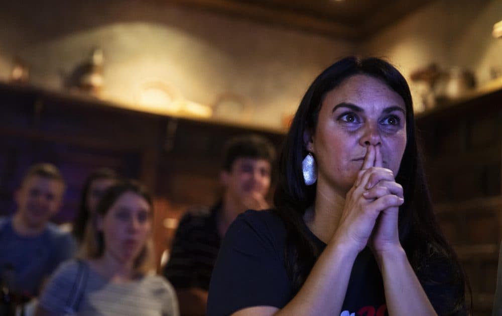 Lacey Hunt, a supporter of Democratic presidential candidate entrepreneur Andrew Yang, watches as he speaks during a Democratic presidential debate at a watch party in Atlanta, Thursday, June 27, 2019. (David Goldman/AP)