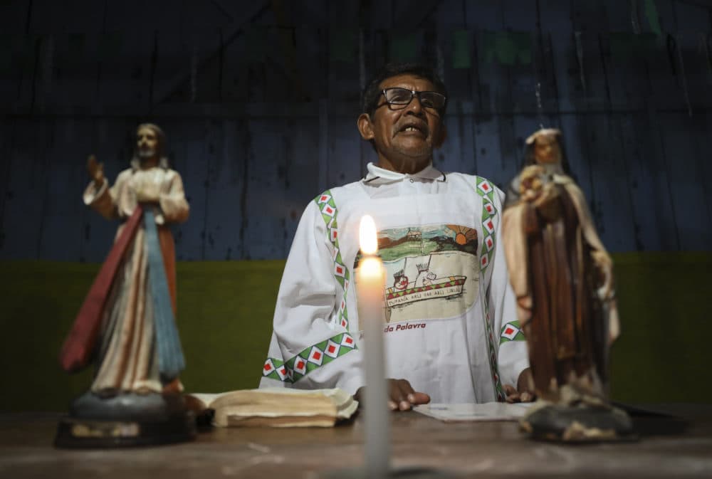 Catholic missionary Antelmo Pereira, 61, leads a prayer service in Santa Rosa, Brazil, Saturday, Sept. 21, 2019. In remote Amazonian communities that are only accessible by boat, villagers can go for months without sacraments that only priests are allowed to deliver - including Mass and confessions, and the faithful have to depend on missionaries like Pereira who are only allowed to lead prayer ceremonies. (Fernando Vergara/AP)