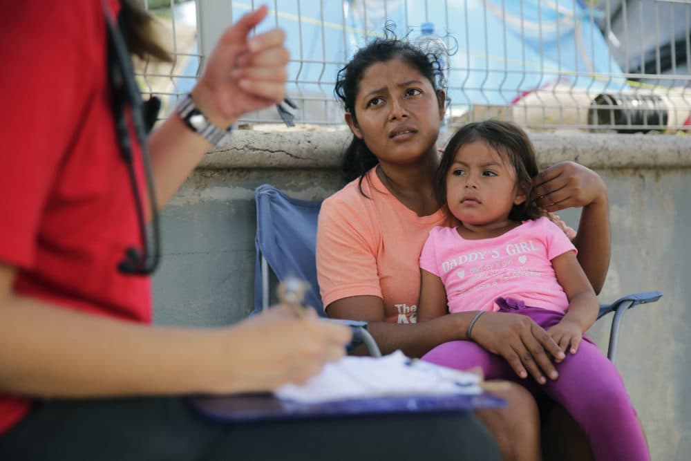 In this Nov. 5, 2019, photo, migrants receive medical care at a sidewalk clinic at refugee camp in Matamoros, Mexico. The doctors and nurses working in the camp are treating people with respiratory problems, skin conditions, diarrhea and other diseases linked to the camp’s unsanitary conditions. (Eric Gay/AP)