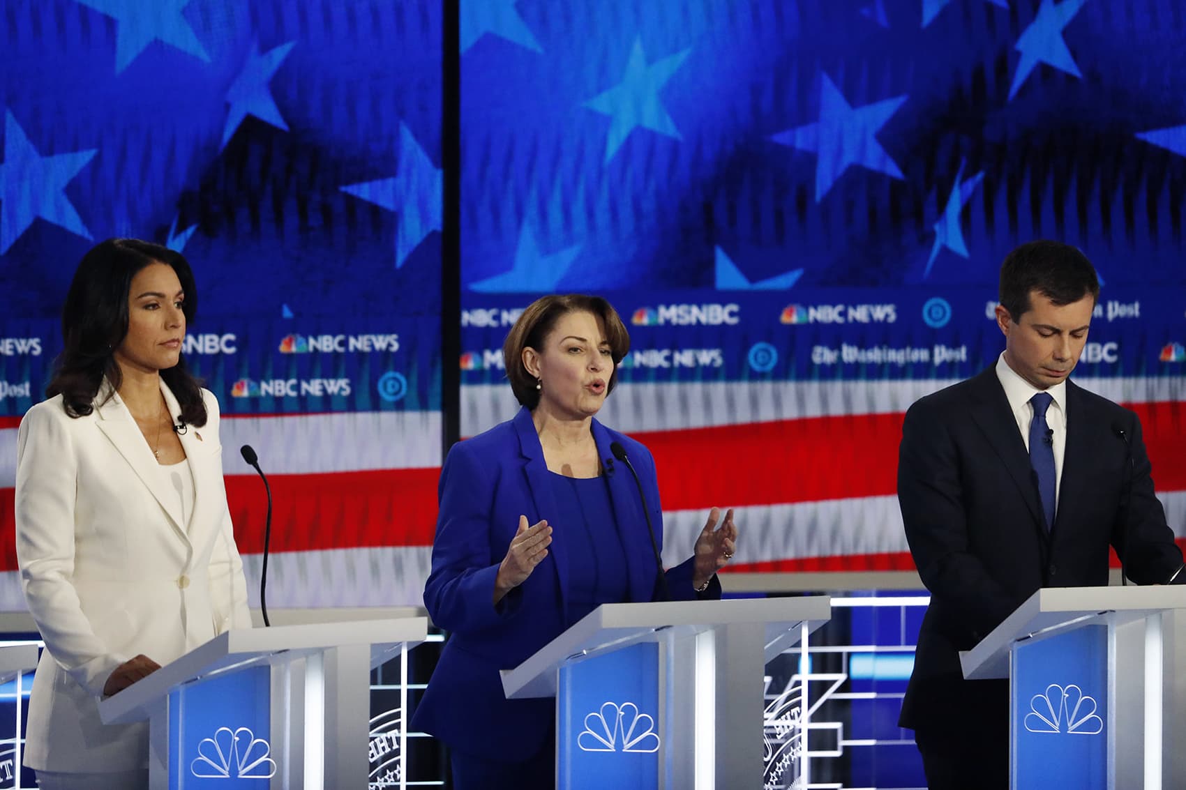 Democratic presidential candidate Sen. Amy Klobuchar, D-Minn., center, speaks as South Bend, Ind., Mayor Pete Buttigieg and Rep. Tulsi Gabbard, D-Hawaii, listen during a Democratic presidential primary debate, Wednesday, Nov. 20, 2019, in Atlanta. (John Bazemore/AP)