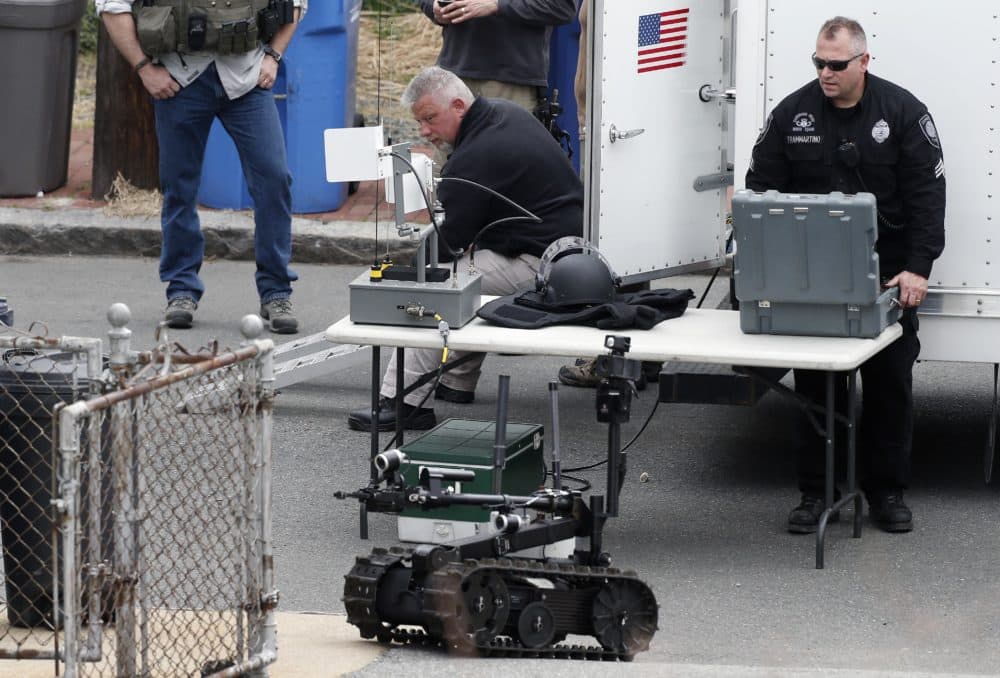 Robots and police departments are no strangers. In this photo, a member of the Cambridge police bomb squad during a search for the Boston Marathon bombings suspect in 2013. (Michael Dwyer/AP)