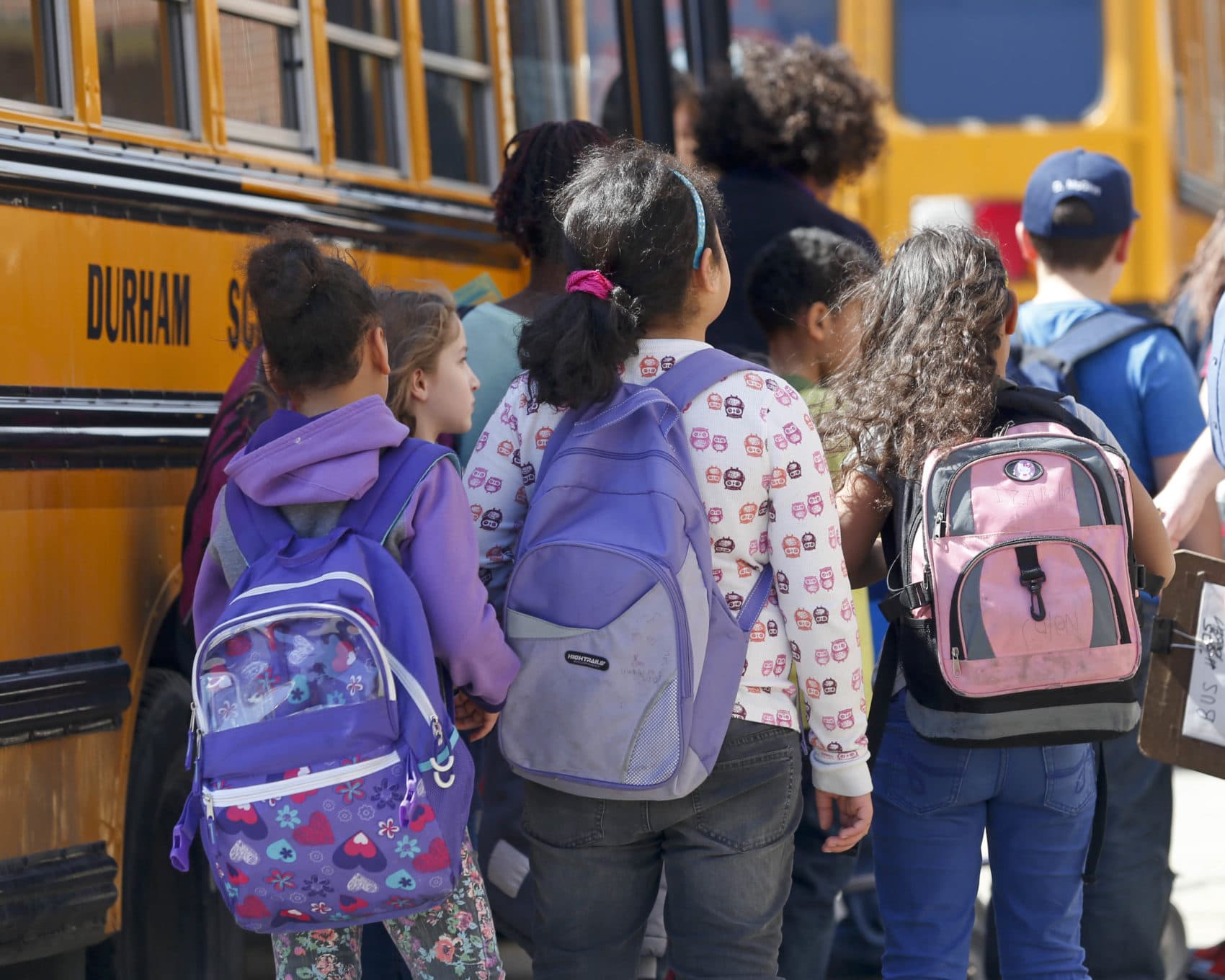 Students at Albany School of Humanities wait to board a bus after school on Monday, April 13, 2015, in Albany, N.Y. With standardized English tests set to begin Tuesday in New York schools, some parents are again planning to have their children sit out the exams. (Mike Groll/AP)