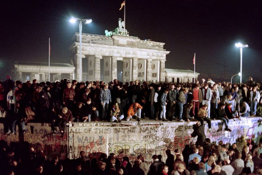 Thousands of young East Berliners crowd atop the Berlin Wall, near the Brandenburg Gate on November 11, 1989. Two days before, Gunter Schabowski, the East Berlin Communist party boss, declared that starting from midnight, East Germans would be free to leave the country, without permission, at any point along the border, including the crossing-points through the Wall in Berlin. (Gerard Malie/AFP/Getty Images)