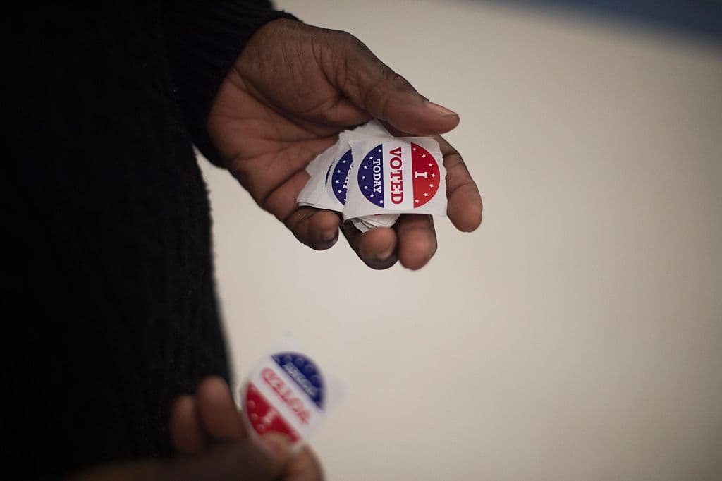 A polling manger holds "I Voted" stickers as she wait for people to cast their ballots in South Carolina. (Jim Watson/AFP/Getty Images)