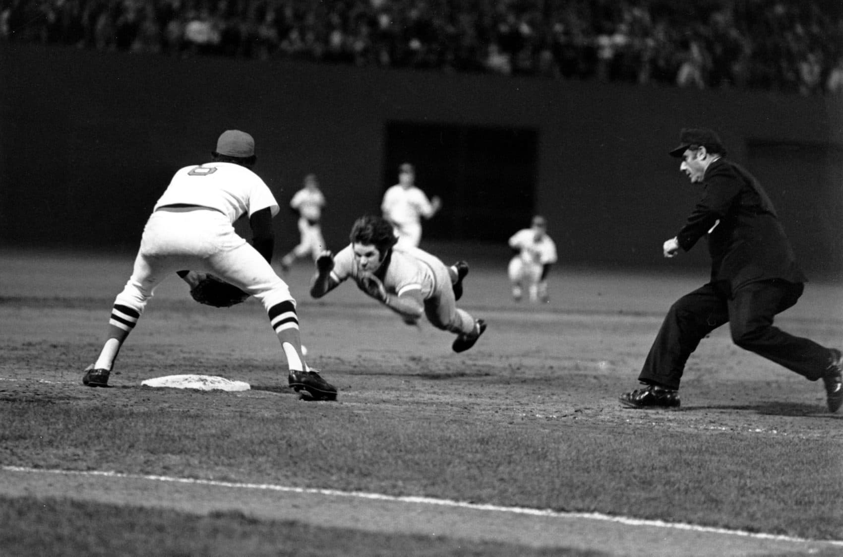 Pete Rose drives in a run in Game 7 of the 1975 World Series 