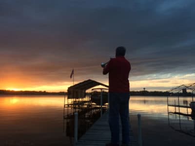 Gary Marquardt plays taps at sunset from his boathouse in Minnesota. (Courtesy John Marquardt)