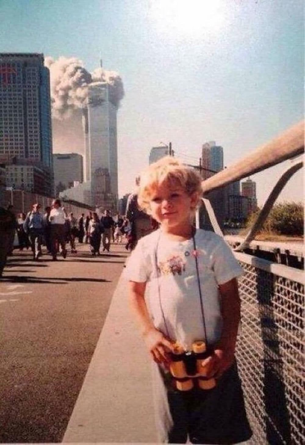 A frequently circulated viral photo, which shows a smiling kid in front of one of the burning World Trade Center towers (courtesy Underunderstood)