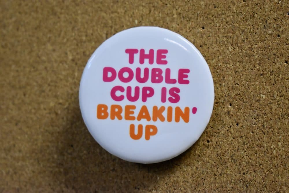A pin that employees at the North Beacon Street location will soon wear, once they get their shipment of the new double-walled paper cups. (Meghan B. Kelly/WBUR)