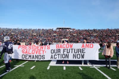 Hundreds of students and alumni take to the field in protest of climate change during Harvard-Yale rivalry football game on Saturday, Nov. 23, 2019 (Courtesy of Fossil Fuel Divest Harvard).