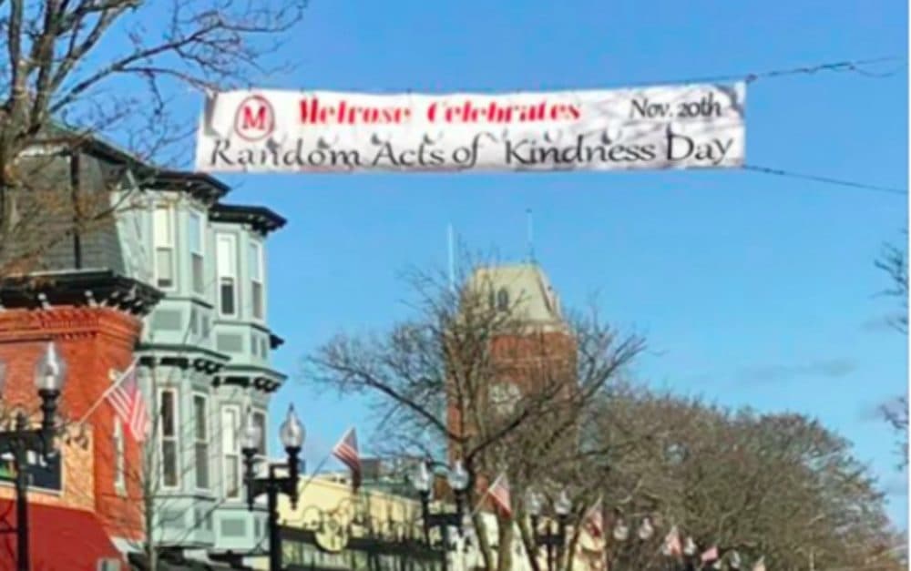 A banner for "Random Acts of Kindness Day" flies above Main Street in Melrose, Massachusetts. (Courtesy)