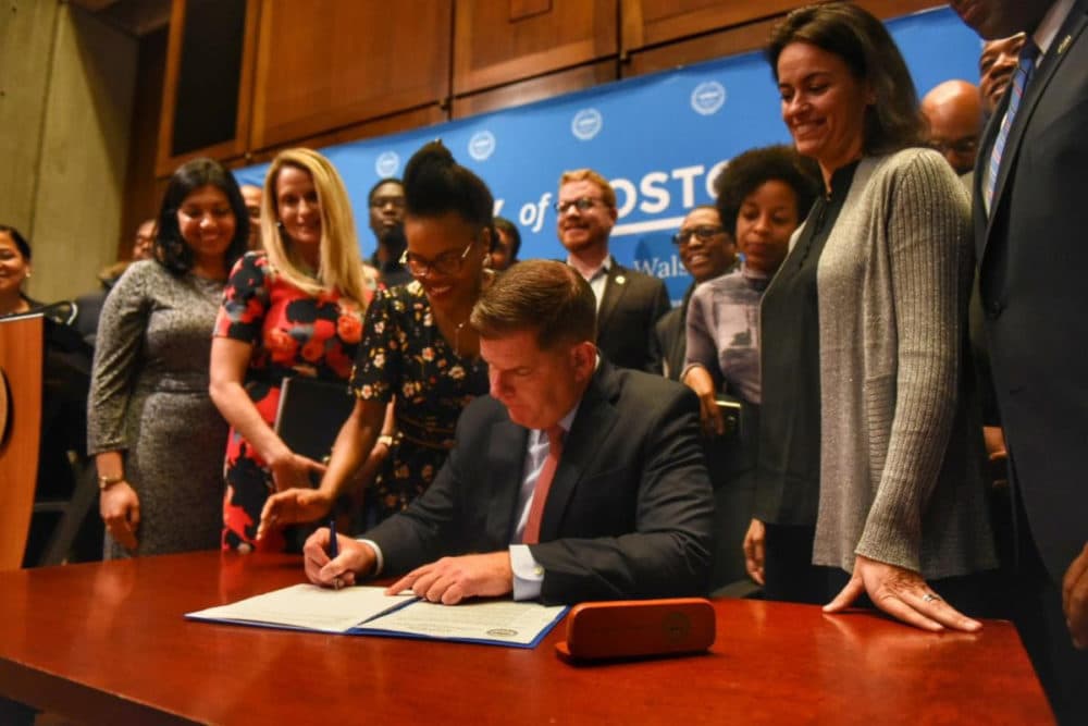 Mayor Marty Walsh signs the ordinance Tuesday. (Courtesy of the mayor's office)
