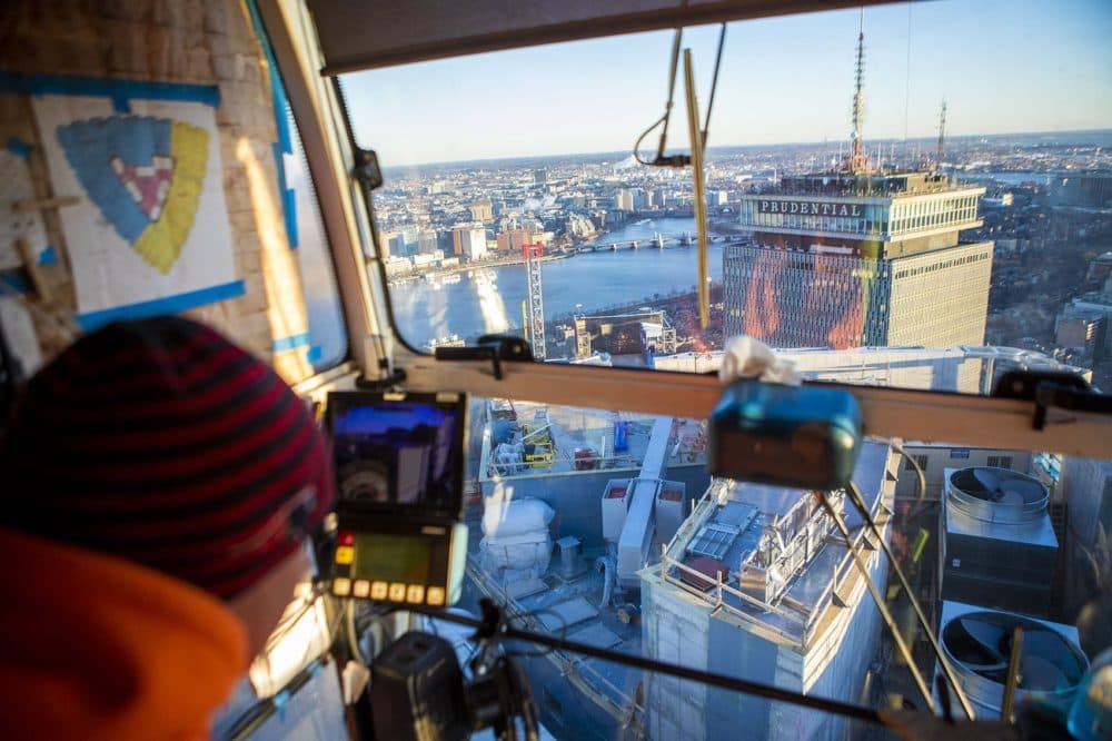 A rare view, looking down at the Prudential Center, as Brett St.Germain operates the crane which sits above One Dalton Street. (Jesse Costa/WBUR)