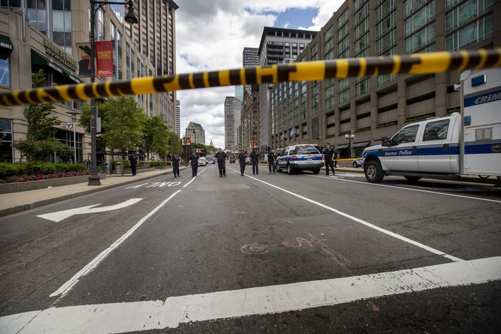 The Boston Police combs Huntington Ave. for additional evidence following a shooting in front of the Colonnade Hotel. (Jesse Costa/WBUR)