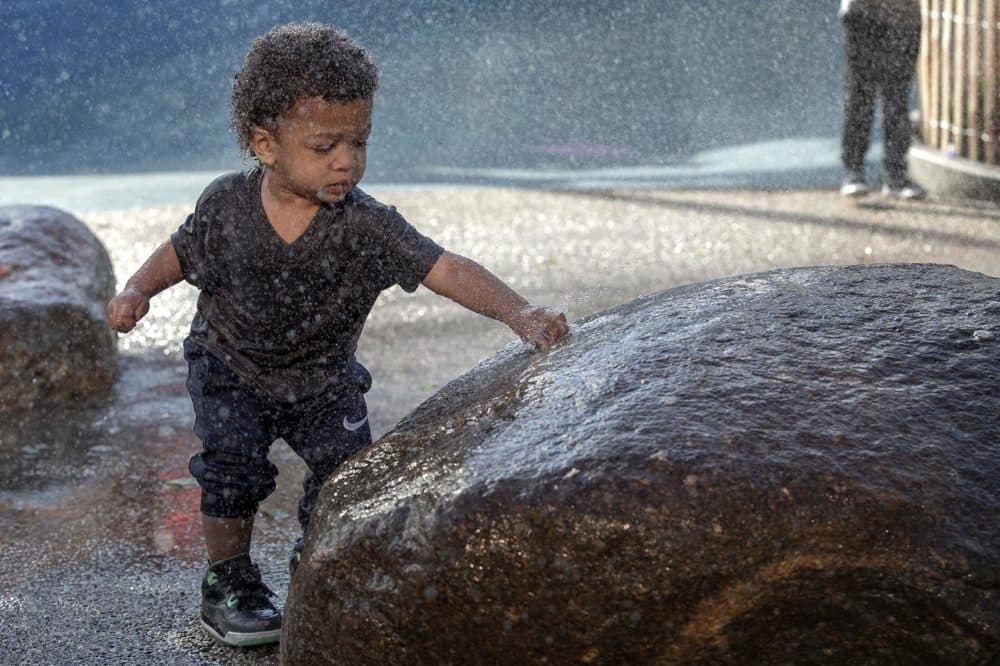 Emmitt, who's 19 months old, plays in the water fountains at Martin's Park. (Robin Lubbock/WBUR)