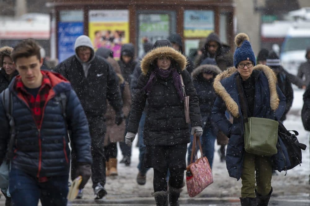 Commuters walk across Boylston St in Copley Sq. during the morning snow. (Jesse Costa/WBUR)