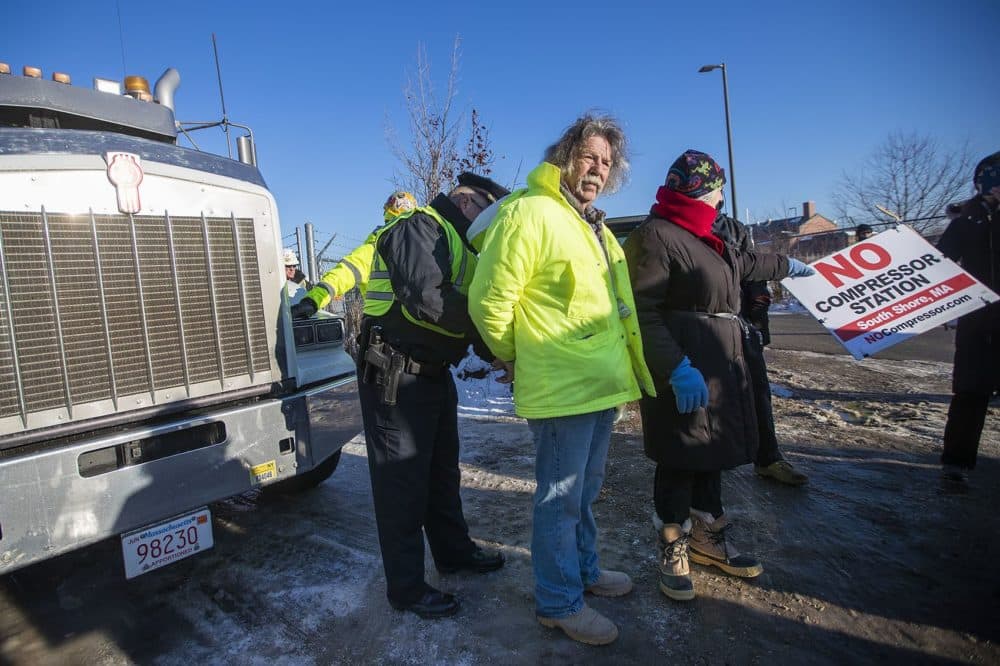 Jerry Grenier is arrested by Weymouth Police outside the Enbridge natural gas compressor site. (Jesse Costa/WBUR)