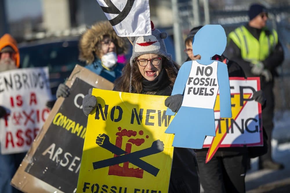 Protesters march and chant in a circle in front of the proposed compressor building site in Weymouth. (Jesse Costa/WBUR)