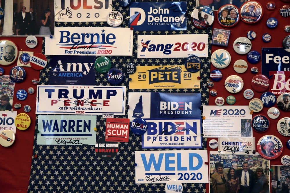Pins and bumper stickers of presidential contenders in the New Hampshire primary are displayed in the State House visitors center on Nov. 14 in Concord, N.H. (Charles Krupa/AP)