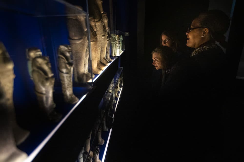 Visitors to the MFA’s Ancient Nubia Now exhibition look at funerary figurines known as “shawabties.” These small sculptures were often buried with Nubian kings and queens, numbering sometimes in the hundreds as guardian sentinels for the afterlife. (Jesse Costa/WBUR)