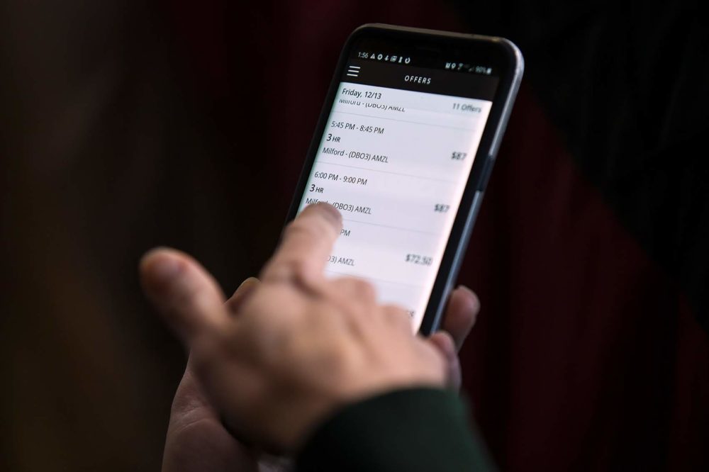 Lynne uses the Amazon Flex app to see a list of available delivery &quot;blocks.&quot; (Jesse Costa/WBUR)