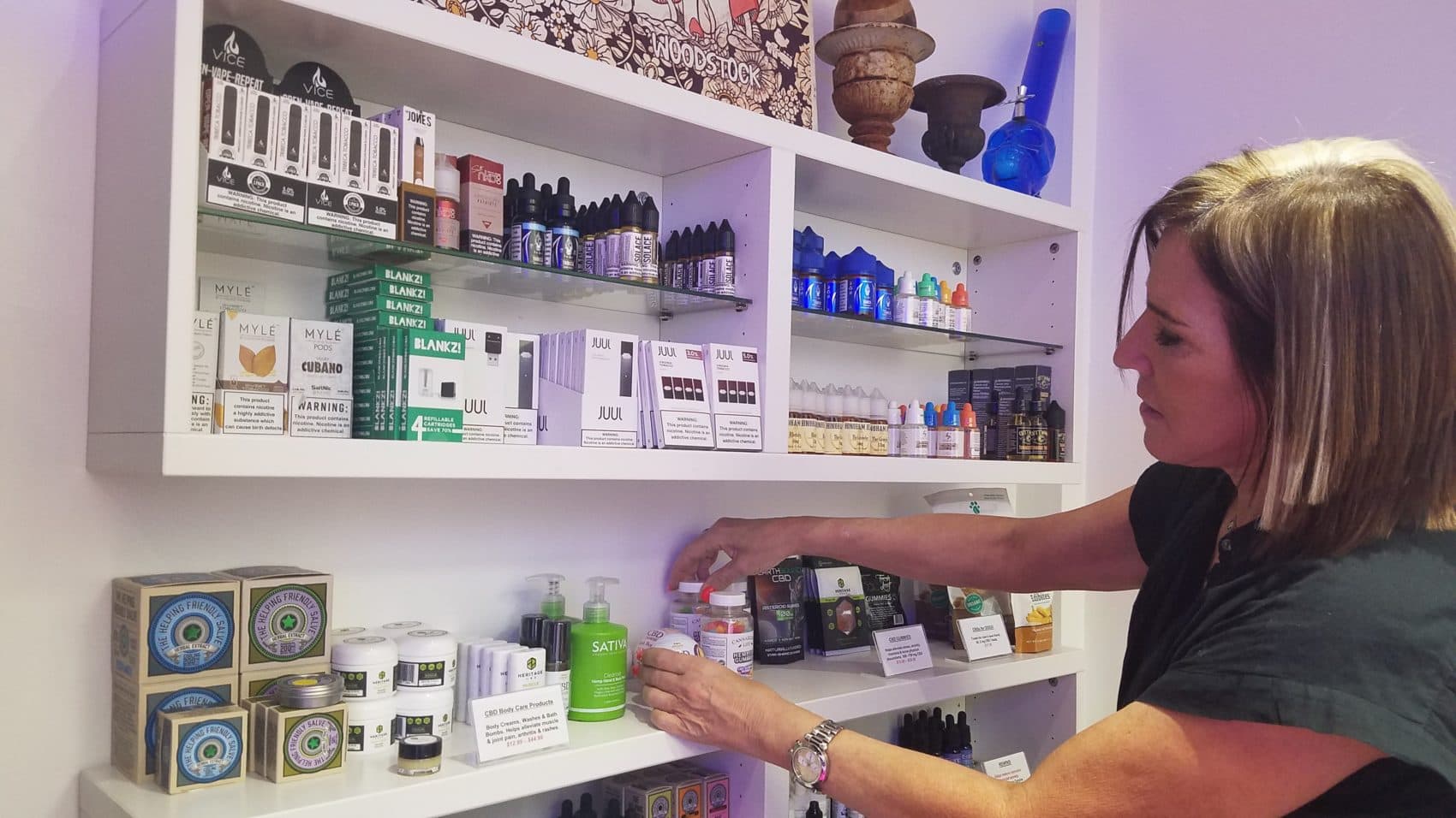 Stacy Poritzky, co-owner of Vape Daddy's in Newton, is re-branding her vape business after a ban on vape sales was lifted in mass. She plans to sell more vaping accessories and CBD products as well as a hydroponic growth system that customers can use to grow marijuana. (Zeninjor Enwemeka/WBUR)
