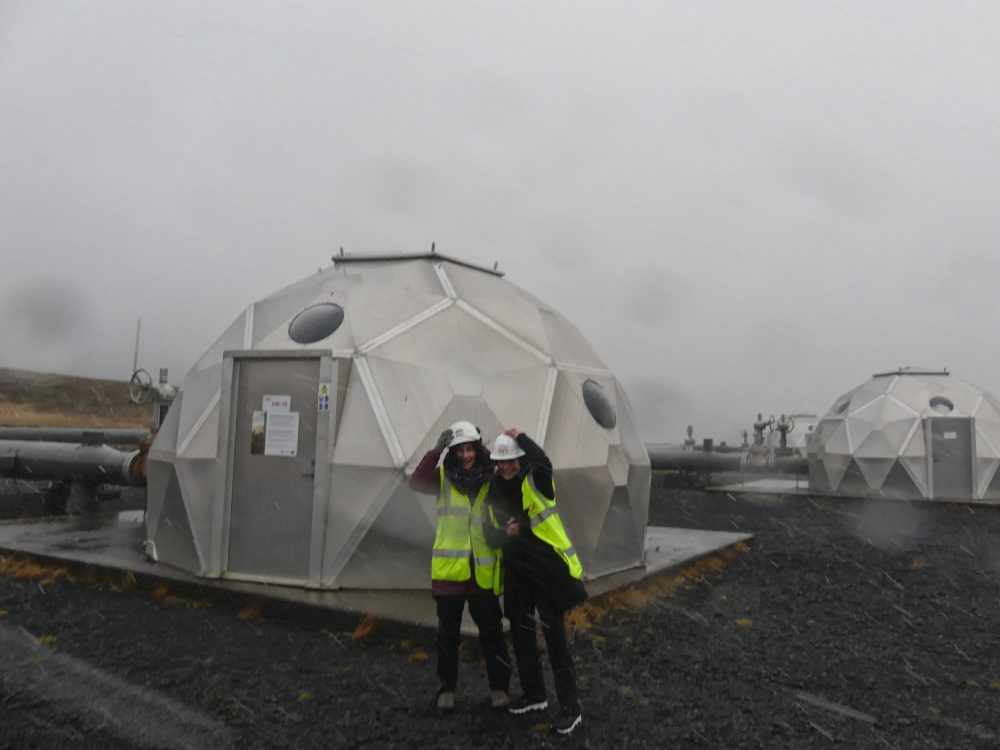 Robin Young and Karyn Miller-Medzon in front of a carbon injection well at the Hellisheiði geothermal plant.