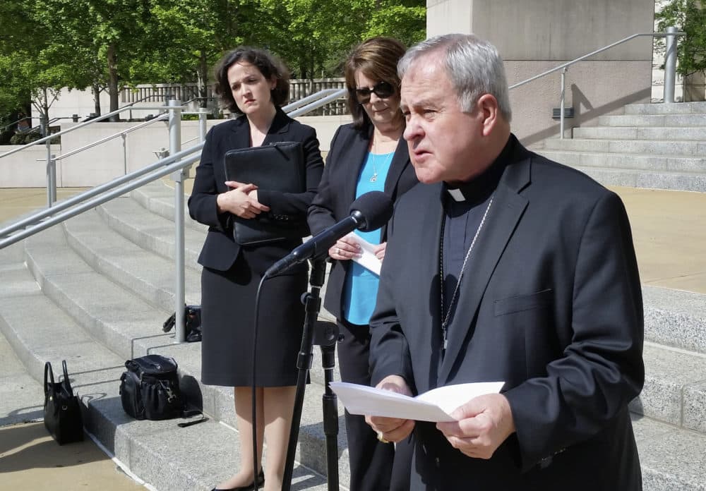 St. Louis Archbishop Robert Carlson speaks at a news conference on May 22, 2017, announcing a federal lawsuit to stop a St. Louis ordinance that prohibits discrimination based on "reproductive health decisions." Behind Carlson is Sarah Pitlyk, left, then of the Thomas More Society, a non-profit law firm that filed the suit. (Jim Salter/AP)