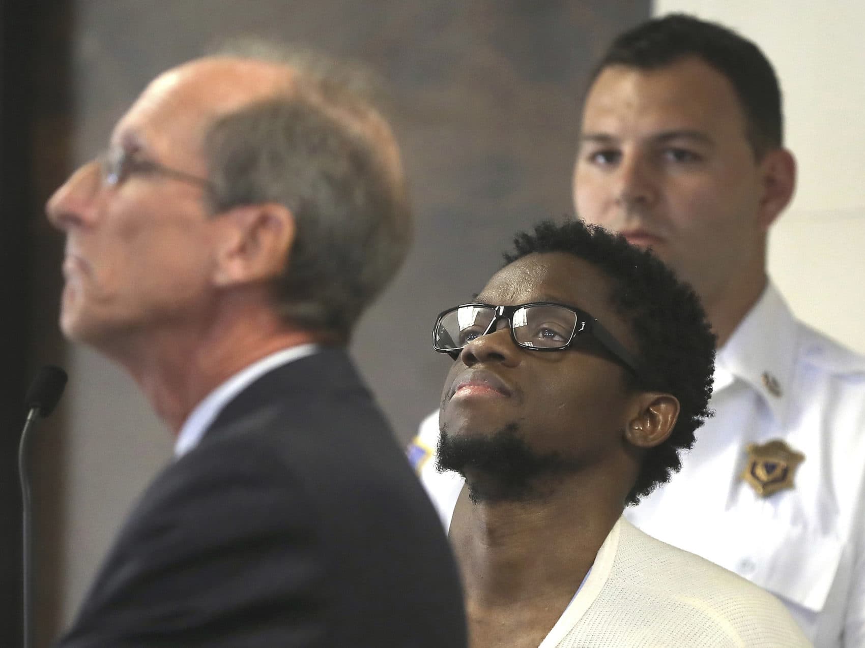 Bampumim Teixeira, center, is arraigned in Suffolk Superior Court in 2017. (Pat Greenhouse/The Boston Globe via AP, Pool, File)