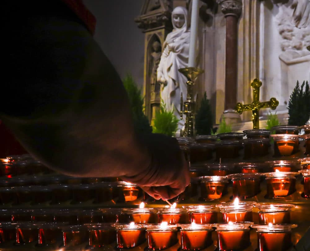A Catholic faithful lights candles at a prayer station during a visit to one of the great symbols of the Roman Catholic Church, St. Patrick's Cathedral, in New York. (Bebeto Matthews/AP)