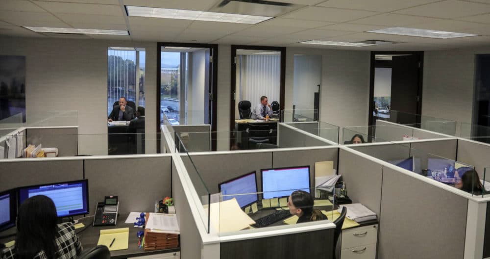 Paralegals work in cubicles at the law firm of Slater, Slater Schulman in Melville, New York. (Bebeto Matthews/AP)