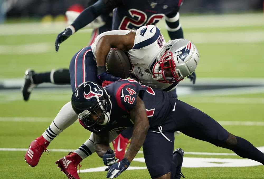 New England Patriots running back James White (28) is hit by Houston Texans cornerback Johnathan Joseph (24) on a run during the first half of the game Sunday in Houston. (David J. Phillip/AP)