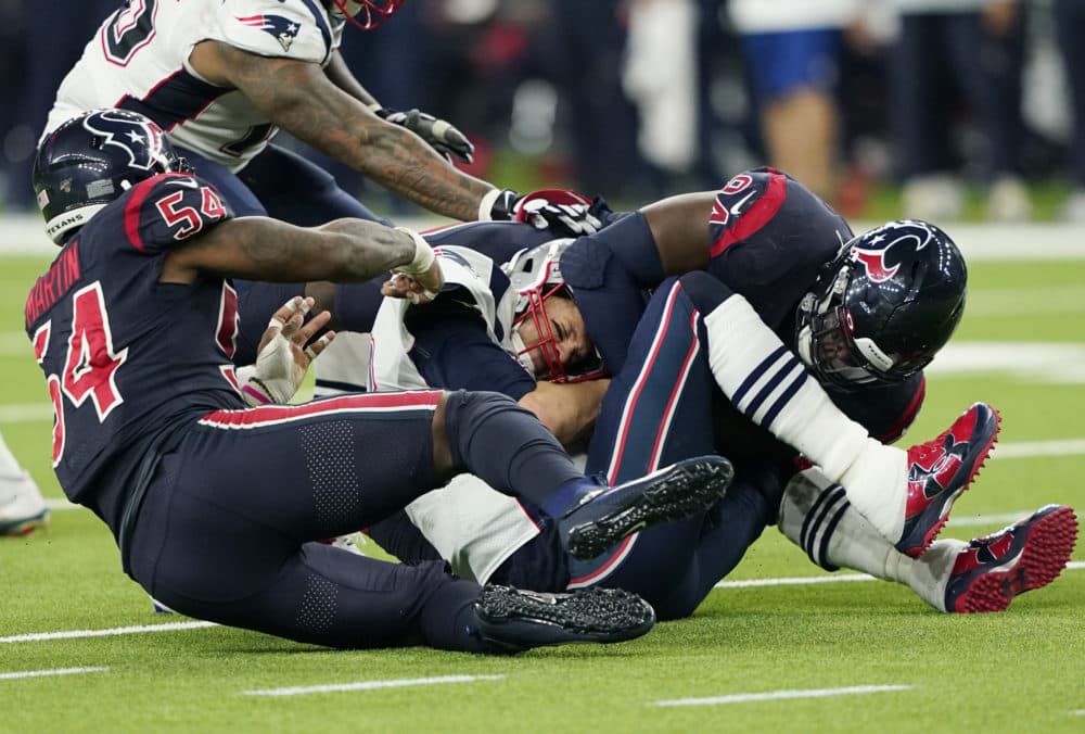 New England Patriots quarterback Tom Brady, center, is sacked by Houston Texans linebacker Jake Martin (54) and defensive end Charles Omenihu (94) during the second half of the game Sunday in Houston. (David J. Phillip/AP)
