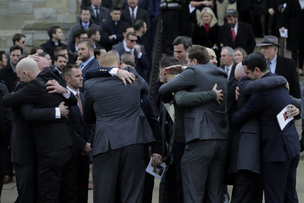 Pallbearers embrace following the funeral of Pete Frates at St. Ignatius of Loyola Parish church at Boston College,. (Charles Krupa/AP)