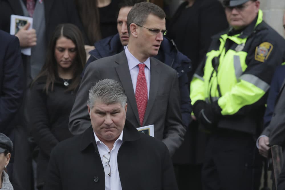 Boston Bruins great Ray Bourque, front, and Boston Red Sox CEO Sam Kennedy depart after the funeral of Pete Frates at St. Ignatius of Loyola Parish church at Boston College. (Charles Krupa/AP)