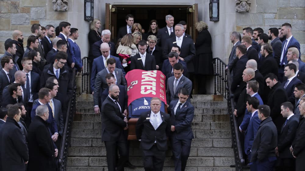 Boston College athletes, from past and present teams, watch as the casket is carried from the funeral of Pete Frates at St. Ignatius of Loyola Parish in Chestnut Hill. (Charles Krupa/AP)