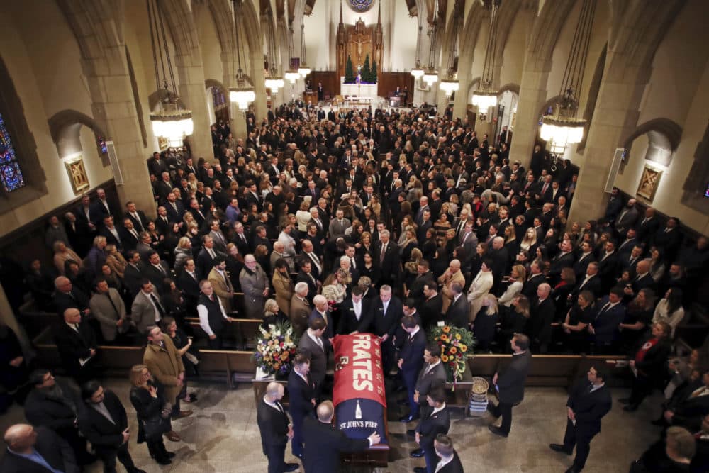 The procession follows the casket of Pete Frates, draped in a flag bearing his name, during a funeral mass at St. Ignatius of Loyola Parish church. (Craig F. Walker/The Boston Globe via AP, Pool)