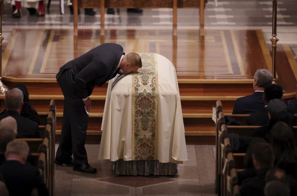 Michael Pitt kisses the casket after his reading during a funeral mass for Pete Frates at St. Ignatius of Loyola Parish church. (Craig F. Walker/The Boston Globe via AP, Pool)