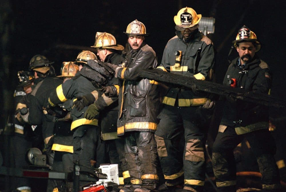 A row of firefighters form a line to remove debris from the fire-gutted Worcester Cold Storage building in the search for the missing firefighters Tuesday, Dec. 7, 1999. (AP photo courtesy Worcester Telegram &amp; Gazette)