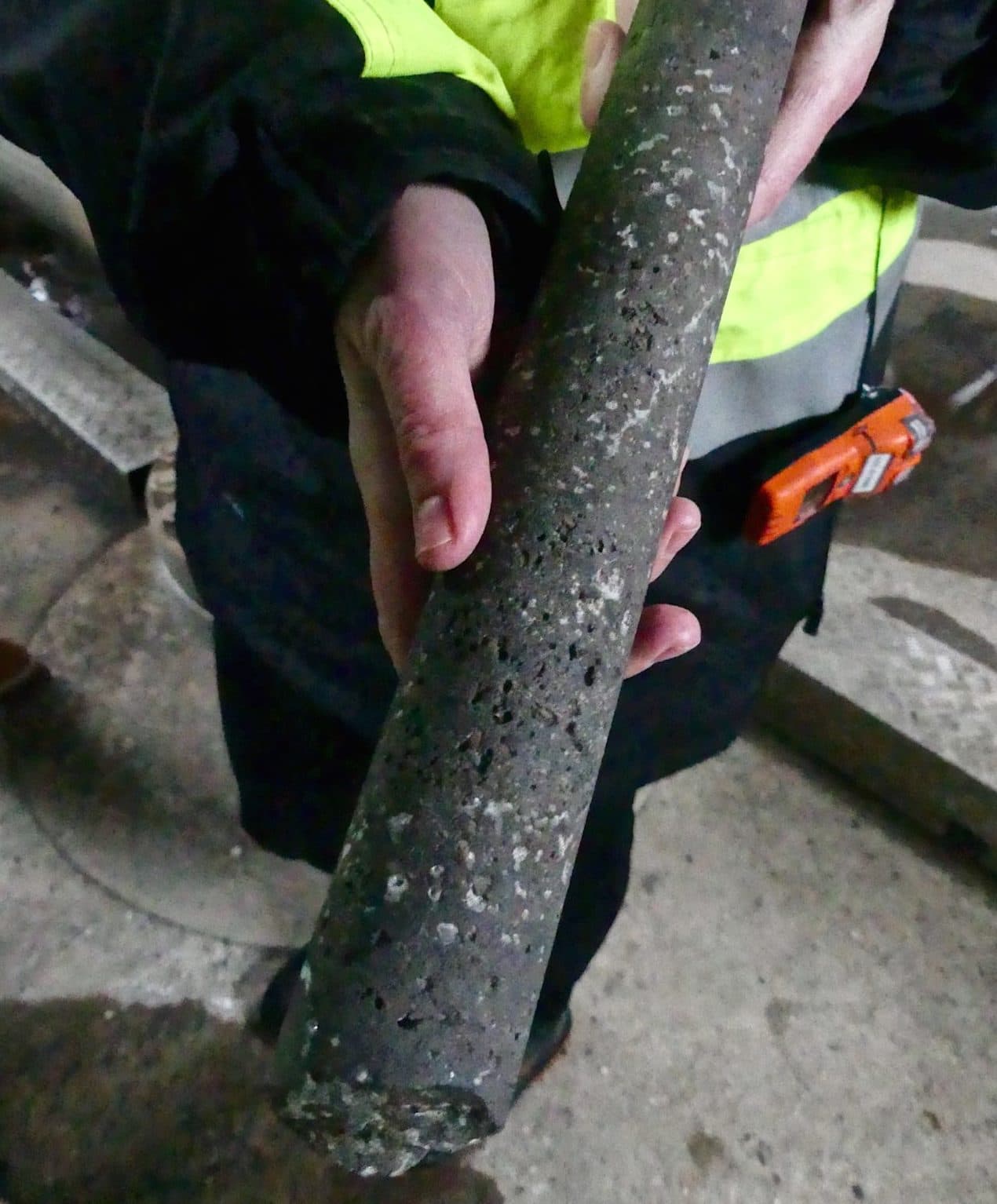 Snæbjörnsdóttir holds a piece of basaltic rock containing crystals of injected carbon. (Karyn Miller-Medzon/Here & Now)