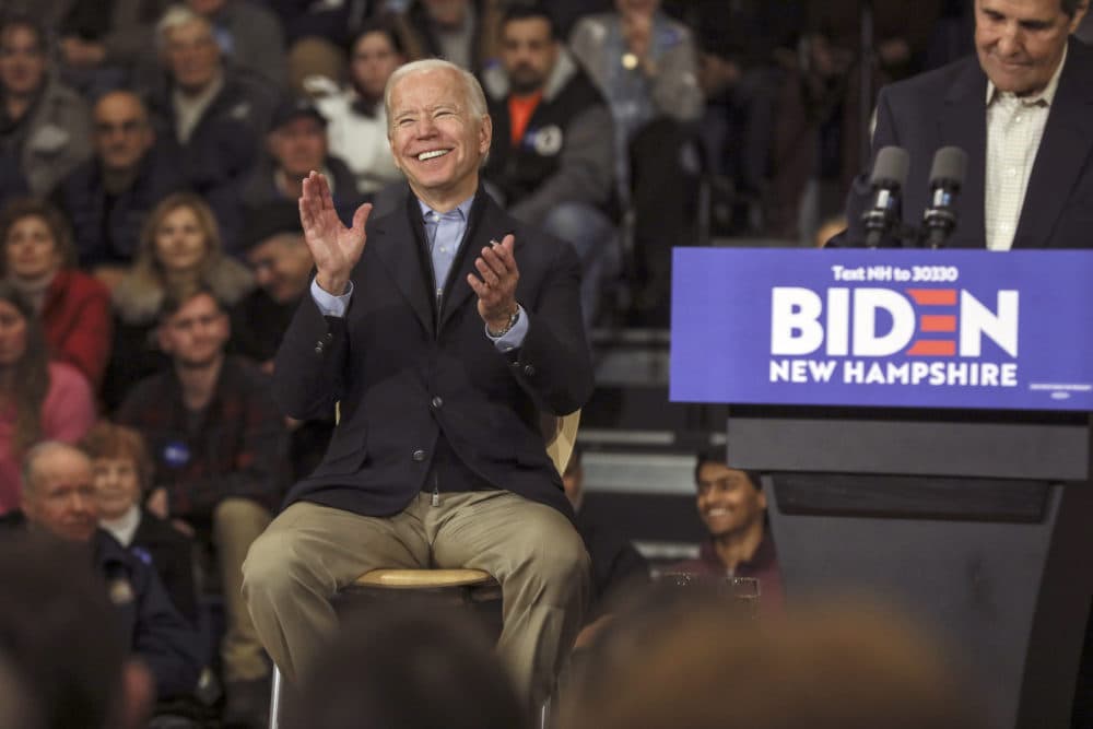Democratic presidential candidate and former Vice President Joe Biden reacts while John Kerry, the former secretary of state and 2004 Democratic presidential nominee speaks at a campaign event in Nashua, N.H. on Dec. 8. (Cheryl Senter/AP)