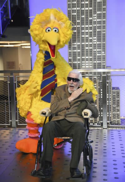 Sesame Street's Big Bird and puppeteer Caroll Spinney participate in the ceremonial lighting of the Empire State Building in honor of Sesame Street's 50th anniversary on Nov. 8, 2019, in New York. (Evan Agostini/Invision/AP)