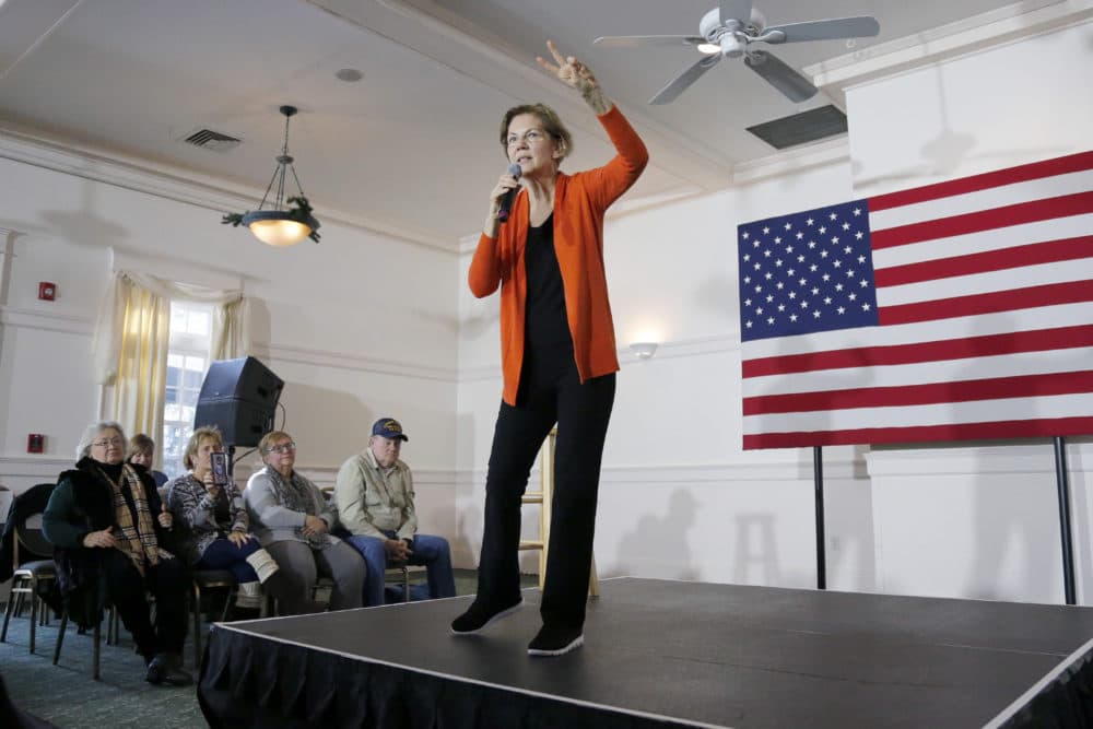 Democratic presidential candidate Sen. Elizabeth Warren, D-Mass., holds up 2 fingers as she talks about her two cent tax as she campaigns on Dec. 7 in Rochester, N.H. (Mary Schwalm/AP)