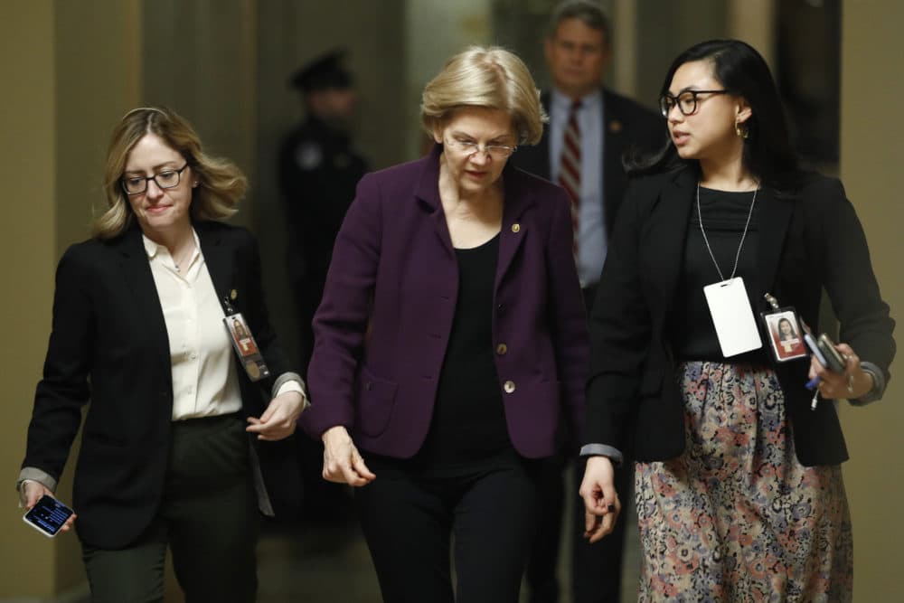 Sen. Elizabeth Warren, D-Mass., center, walks with aides to the Senate chamber after a break in the impeachment trial of President Trump on Wednesday. (Steve Helber/AP)
