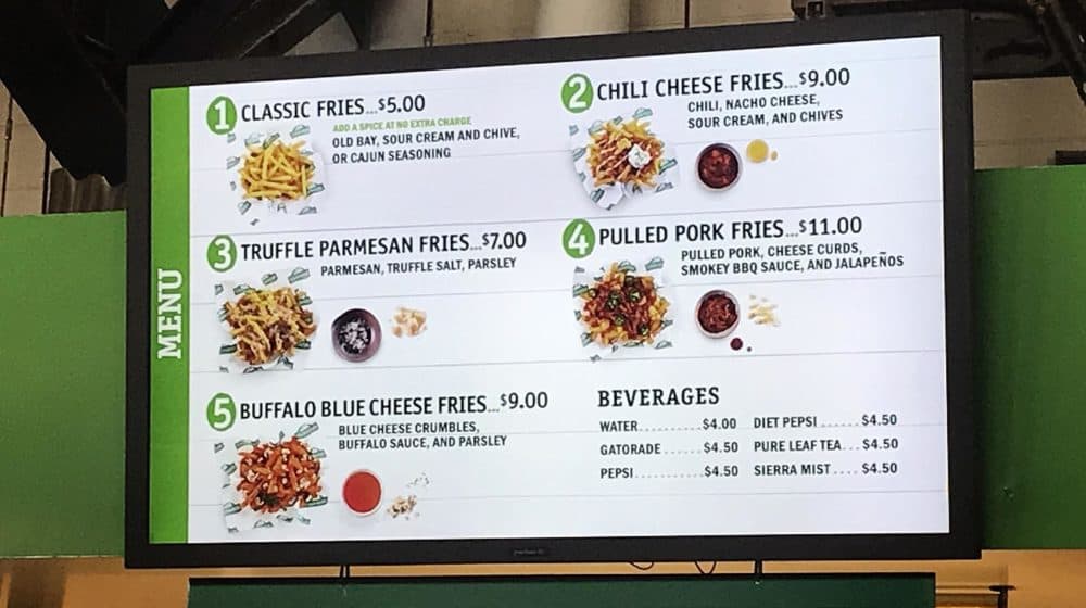 You can get loaded fries at this stand in Gillette Stadium. Once a realm of hot dogs and beer, stadiums now offer higher-quality food -- for a higher price. (Shira Springer/WBUR)