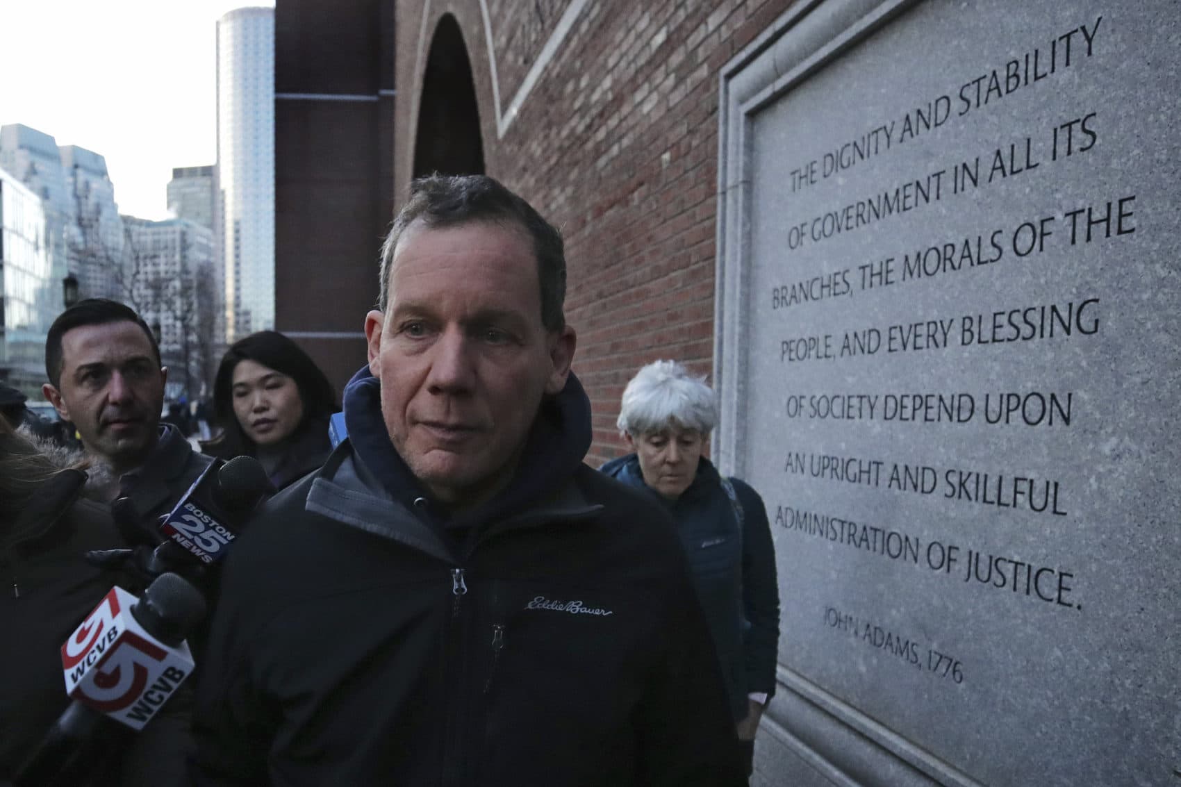 Harvard University professor Charles Lieber leaves the Moakley Federal Courthouse with his wife Jennifer, right, in Boston Thursday. (Charles Krupa/AP)