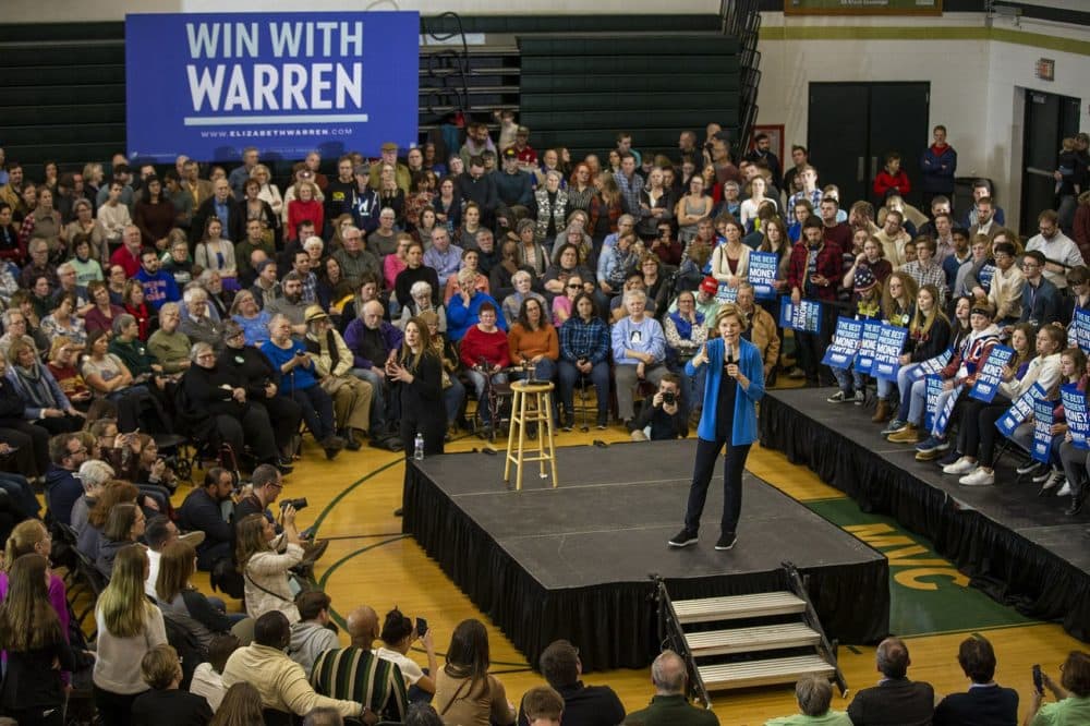 Warren speaks to the crowd at West High School in Iowa City, Iowa. (Jesse Costa/WBUR)