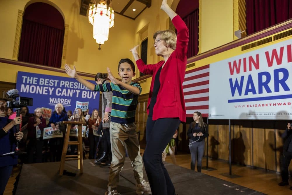 Presidential candidate Elizabeth Warren dances on stage with her nine-year-old grandson Atticus at the end of her campaign speech at Iowa State University in Ames. (Jesse Costa/WBUR)