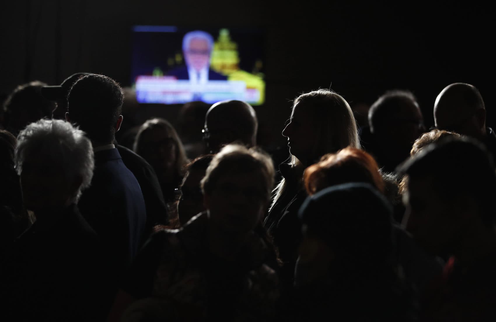 People wait for results at a caucus night campaign rally for democratic presidential candidate former Vice President Joe Biden on Monday in Des Moines, Iowa. (John Locher/AP)