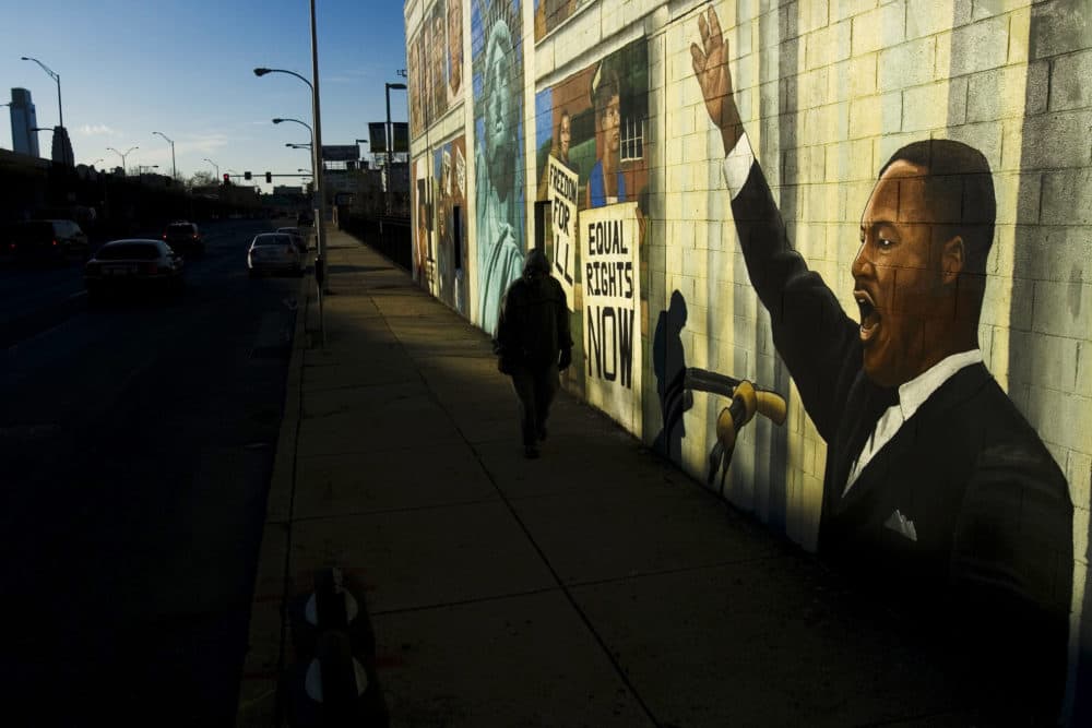 A person walks past a mural of Martin Luther King in Philadelphia, Friday, Jan. 18, 2008. Monday, Jan. 21, 2008 is Martin Luther King Day. (Matt Rourke/AP)